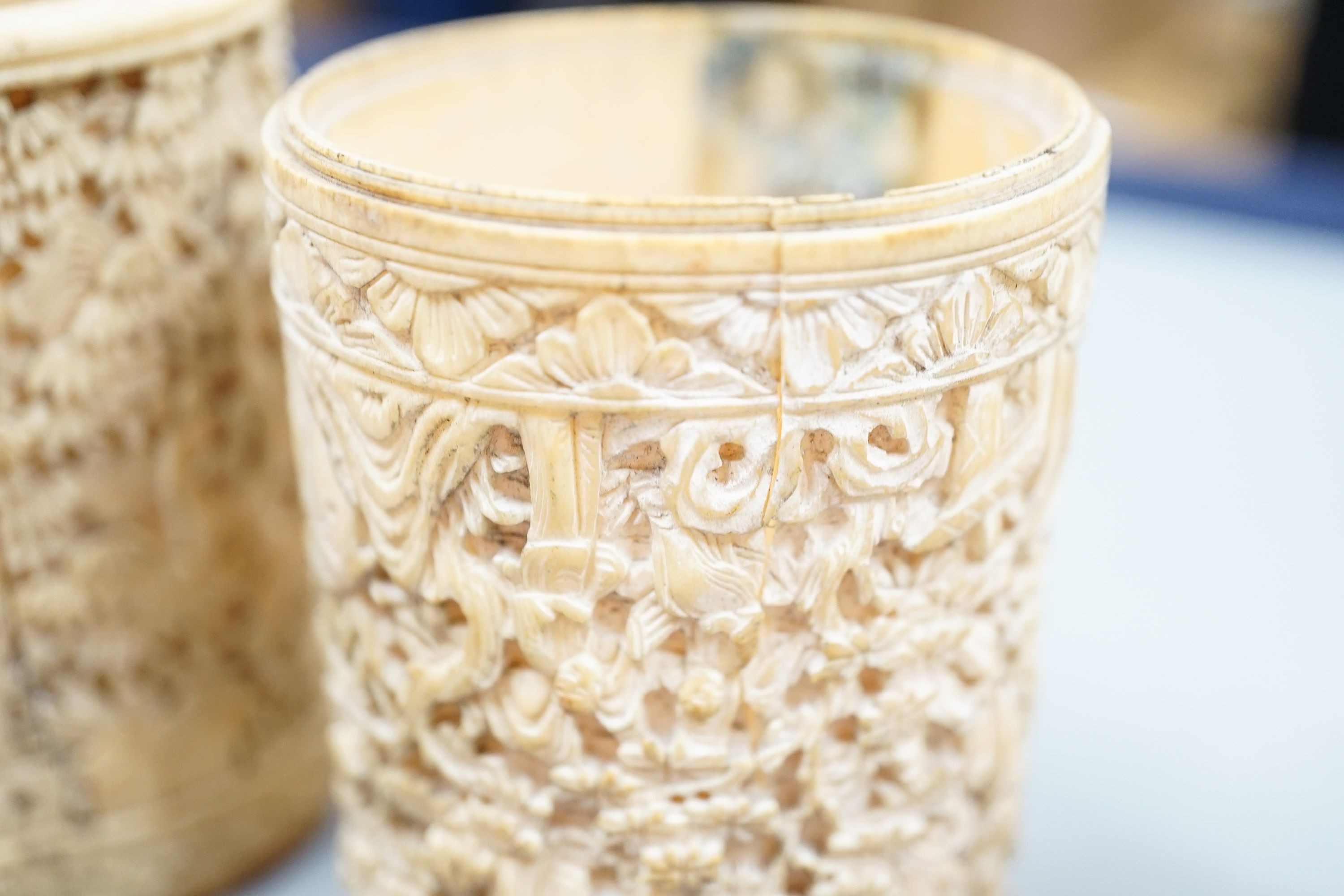 A pair of Chinese carved ivory pots and a Chinese ivory circular box and cover, 19th century